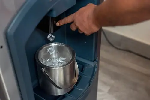 person dispensing ice from ice machine