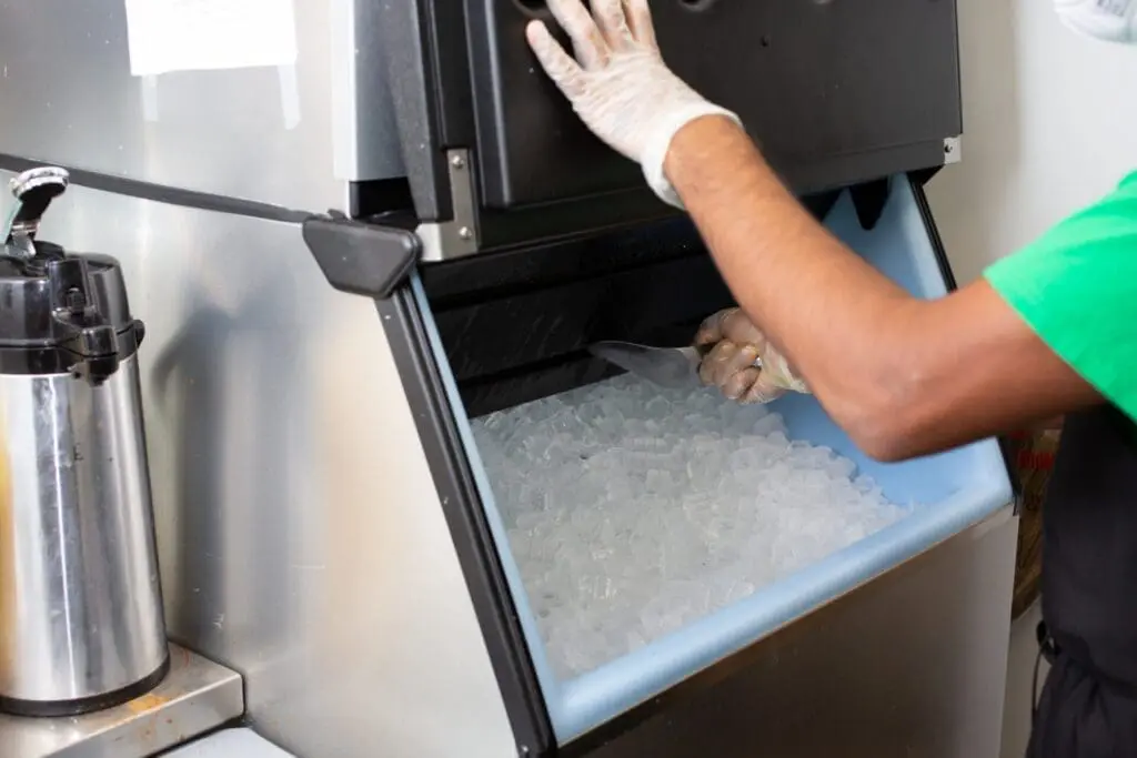 person scooping ice